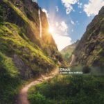 Amazing Himalayan mountains covered green grass, high waterfall, beautiful path, green trees, blue sky with yellow sun and clouds in Nepal at sunset. Mountain canyon. Travel in Himalayas.Landscape